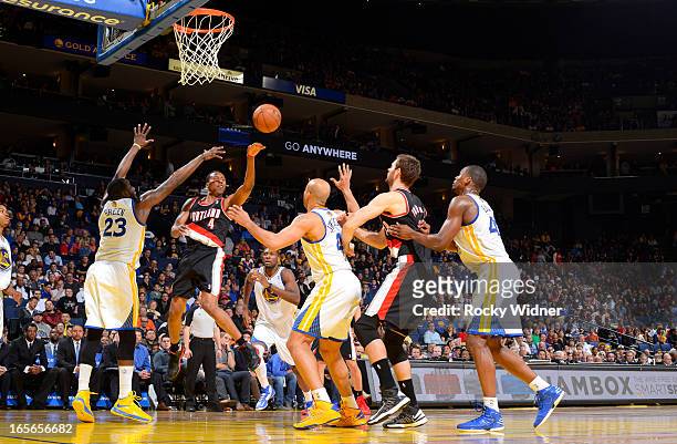 Nolan Smith of the Portland Trail Blazers passes against Draymond Green of the Golden State Warriors on March 30, 2013 at Oracle Arena in Oakland,...
