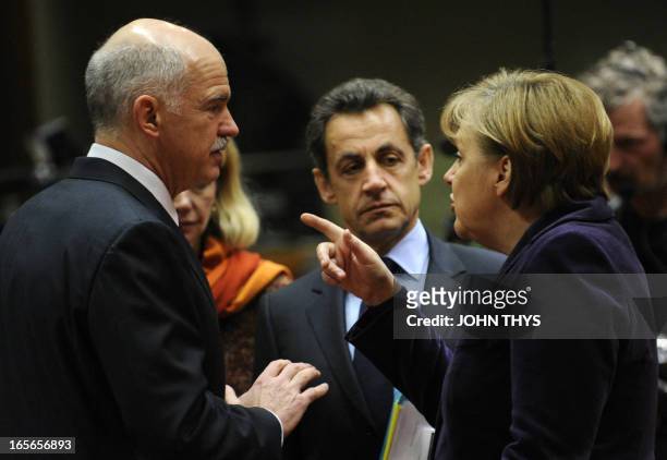 German Chancellor Angela Merkel and French President Nicolas Sarkozy talk with Greek Prime Minister George A. Papandreou prior to a working session...