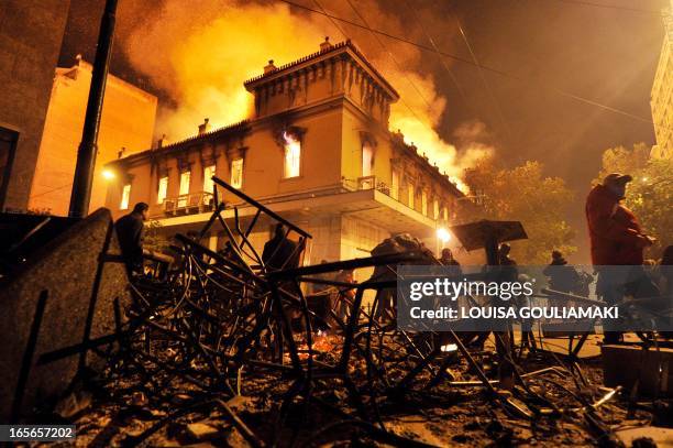 Fire engulfs a store during clashes between protesters and riot police near the Greek parliament in Athens on February 12, 2012. Greek police fired...