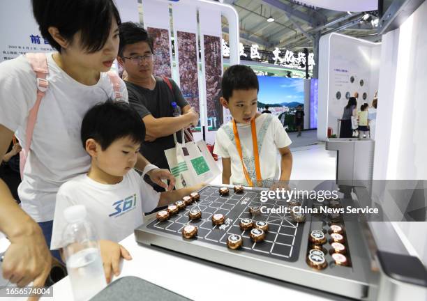 Child views a robot playing chess during the 2023 China International Fair for Trade Services at Shougang Park on September 2, 2023 in Beijing, China.