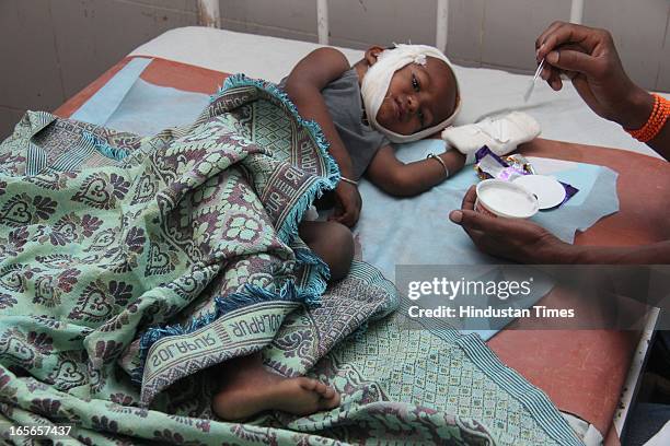 Medical staff offering ice cream to injured children who survived the building collapse at Lucky compound at Shivaji Hospital on April 5, 2013 in...