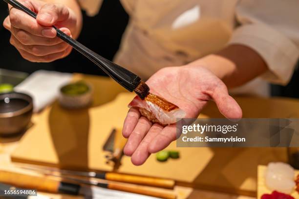 close up of chef preparing nigiri sushi - sea bream stock pictures, royalty-free photos & images