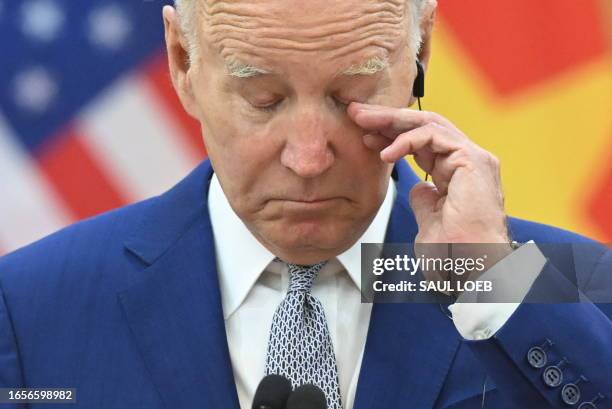 President Joe Biden gestures as Vietnam's Communist Party General Secretary Nguyen Phu Trong speaks to the media at the Communist Party of Vietnam...