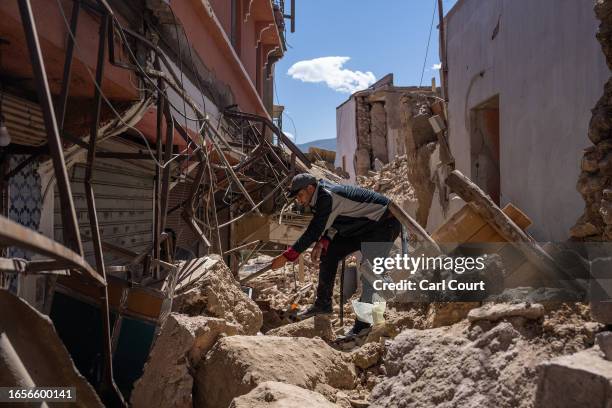 Man tries to open a heavily damaged building following yesterday's earthquake, on September 10, 2023 in Moulay Brahim, Morocco. A huge earthquake...