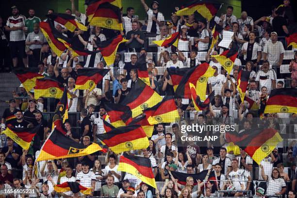 Germany fans with the national flag during the friendly Interland match between Germany and Japan at the Volkswagen Arena on September 9, 2023 in...