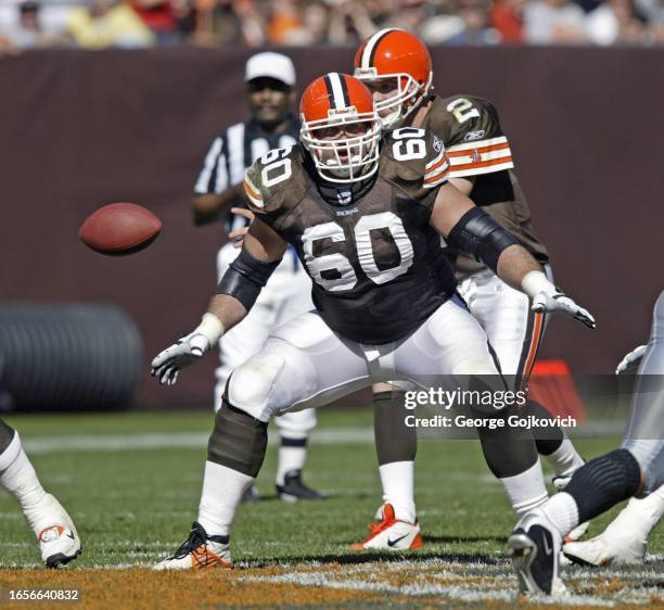 Guard Shaun O'Hara of the Cleveland Browns blocks as quarterback Tim Couch waits to receive the football from center during a game against the...