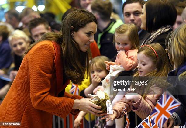 Britain's Catherine, Duchess of Cambridge receives a gift from a well-wisher as she visits the Astute-class Submarine Building at BAE Systems in...