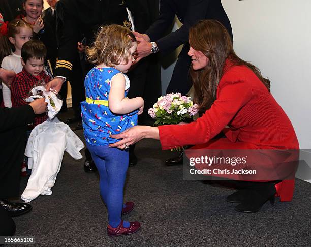 Catherine, Countess of Strathearn helps Maizie Yeardley adjust her dress during a visit the Astute-class Submarine Building at BAE Systems on April...