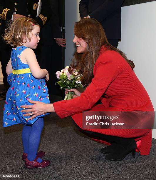 Catherine, Countess of Strathearn helps Maizie Yeardley adjust her dress during a visit the Astute-class Submarine Building at BAE Systems on April...