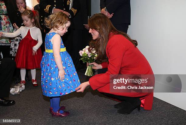 Catherine, Countess of Strathearn helps Maizie Yeardley adjust her dress during a visit the Astute-class Submarine Building at BAE Systems on April...