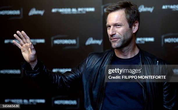 Actor Aaron Eckhart poses during a photocall for the movie "Olympus has fallen" in downtown Rome on April 5, 2013. AFP PHOTO / Filippo MONTEFORTE