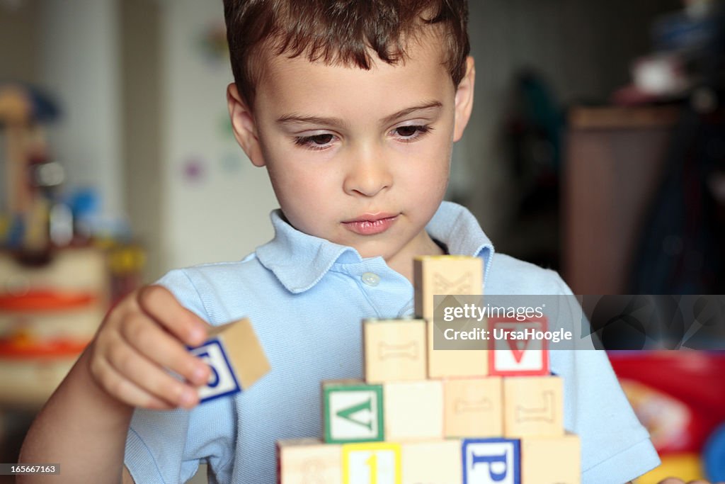 Autistic boy building with blocks