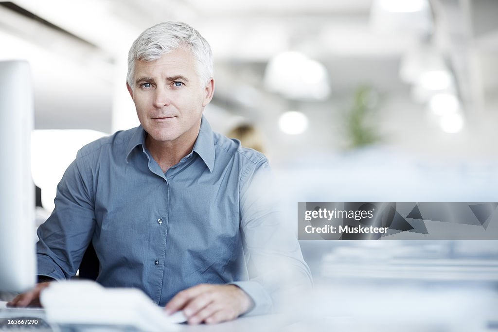 Experienced businessmansitting at his desk