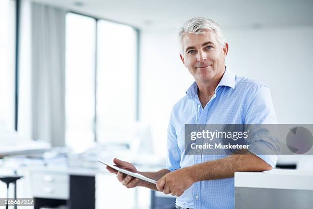 Man Looking In Camera While Working On His Tablet, 照片檔