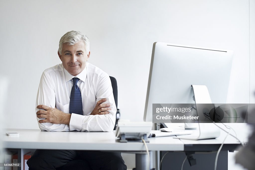 Confident manager at his desk