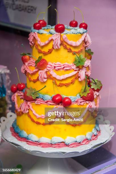 colourful multi-tier vegan cake on sale at bakery - cake tier stock pictures, royalty-free photos & images