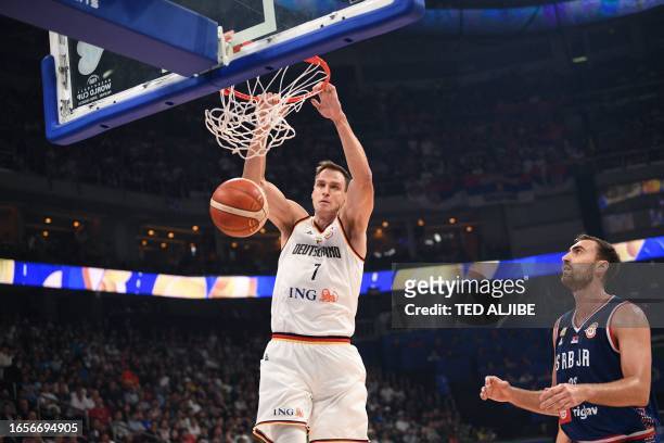 Germany's Johannes Voigtmann dunks the ball against Serbia during the FIBA Basketball World Cup final game between Germany and Serbia in Manila on...