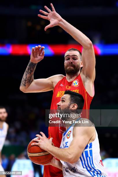 Kostas Papanikolaou of Greece drives to the basket against Nemanja Radovic of Montenegro in the fourth quarter during the FIBA Basketball World Cup...