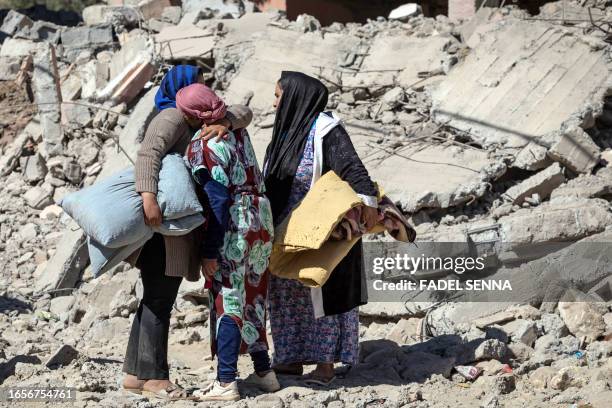 Villagers mourn next to collapsed houses in Tafeghaghte, 60 kilometres southwest of Marrakesh, on September 10 two days after a devastating...