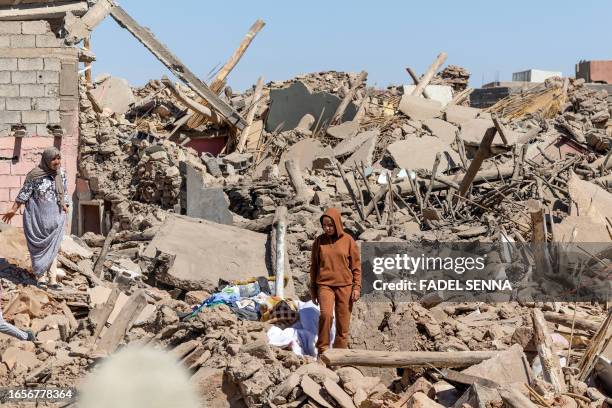 Villagers inspect the rubble of collapsed houses in Tafeghaghte, 60 kilometres southwest of Marrakesh, on September 10 two days after a devastating...