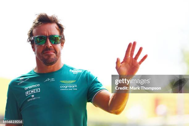 Fernando Alonso of Spain and Aston Martin F1 Team waves to the crowd on the drivers parade prior to the F1 Grand Prix of Italy at Autodromo Nazionale...