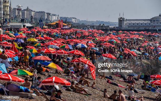 Crowds pack the beach in Brighton as the UK sees the longest September heatwave ever.