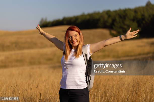 happy caucasian woman enjoying beautiful day in nature - freckle arm stock pictures, royalty-free photos & images