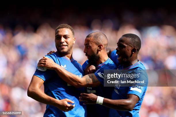 Kemar Roofe of Rangers celebrates with teammates Cyriel Dessers and Rabbi Matondo after scoring the team's first goal which was later disallowed by...
