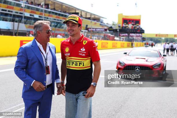 Charles Leclerc of Monaco and Ferrari talks with Jean Alesi on the drivers parade prior to the F1 Grand Prix of Italy at Autodromo Nazionale Monza on...