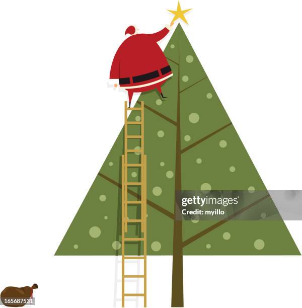 santa claus putting the star on christmas tree - tree topper stock illustrations