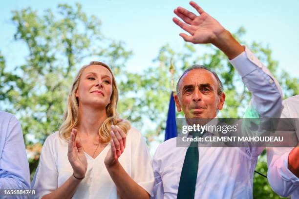 France's far-right party "Reconquete" leader Eric Zemmour and Executive Vice President of "Reconquete" Marion Marechal greet supporters on stage...