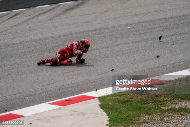 Francesco Bagnaia of Italy and Ducati Lenovo Team after he hit by Brad Binder of South Africa and Red Bull KTM Factory Racing during the race of the...
