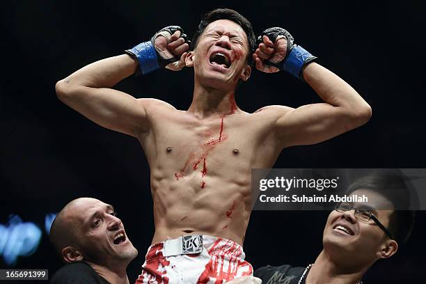 Chen Yun Ting of Malaysia celebrates after defeating Ronald Low of Singapore during the One Fighting Championship at Singapore Indoor Stadium on...