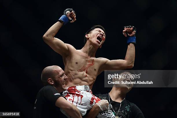 Chen Yun Ting of Malaysia celebrates after defeating Ronald Low of Singapore during the One Fighting Championship at Singapore Indoor Stadium on...