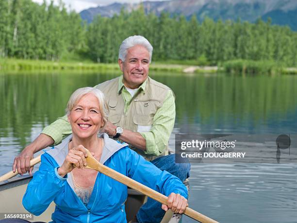 retired couple - seniors canoeing stock pictures, royalty-free photos & images