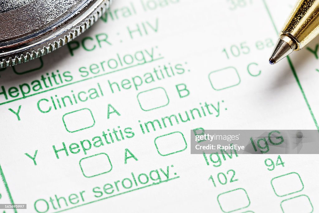Stethoscope and pen on blood test form for hepatitis