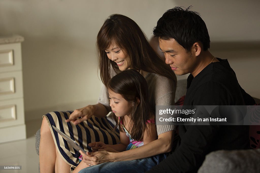 Family at home using digital tablet