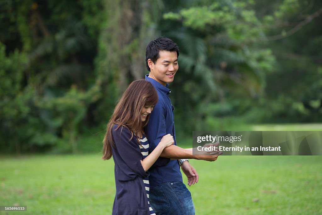 Young couple walking together in park