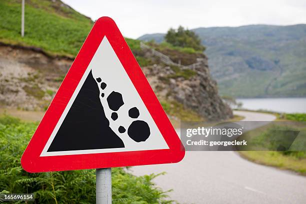 falling rocks warning road sign - avalanche bildbanksfoton och bilder