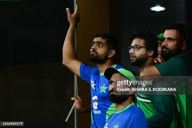 Pakistan's captain Babar Azam with teammates look on, after a rain delay, during the Asia Cup 2023 super four one-day international cricket match...