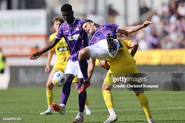 Maximilian Thalhammer of Osnabrueck falls over Wahid Faghir of Elversberg during the Second Bundesliga match between VfL Osnabrück and SV Elversberg...