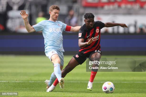 Junior Dina Ebimbe of Eintracht Frankfurt battles for possession with Florian Kainz of 1.FC Köln during the Bundesliga match between Eintracht...