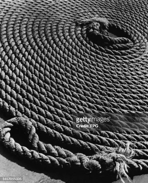 Close-up view of a coil of rope with a frayed end in the foreground, United States, circa 1935.