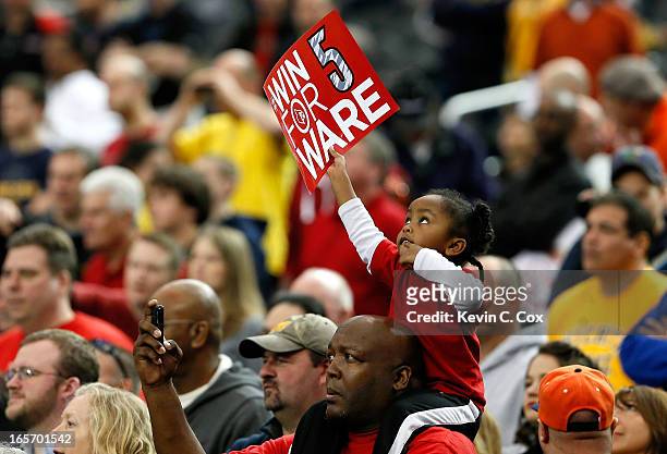 Young fan of the Louisville Cardinals holds up a sign, which reads "Win for Ware" in reference to injured Louisville guard Kevin Ware who suffered a...