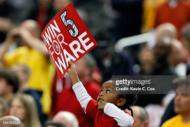 Young fan of the Louisville Cardinals holds up a sign, which reads "Win for Ware" in reference to injured Louisville guard Kevin Ware who suffered a...