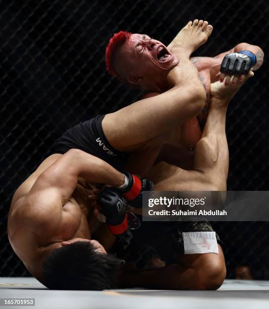 Eddie Ng of Hong Kong locks Arnaud Lepont of France for a submission win during the One Fighting Championship at Singapore Indoor Stadium on April 5,...