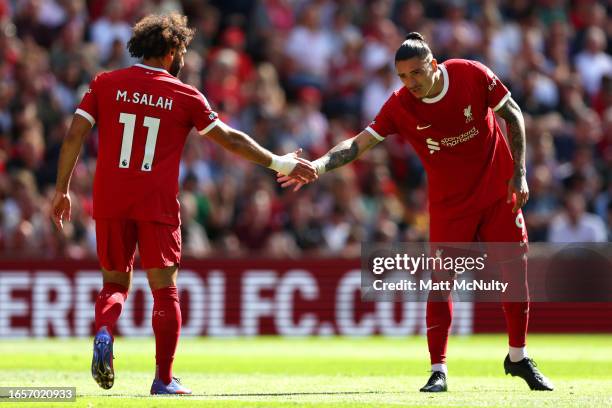 Darwin Nunez of Liverpool interacts with teammate Mohamed Salah during the Premier League match between Liverpool FC and Aston Villa at Anfield on...