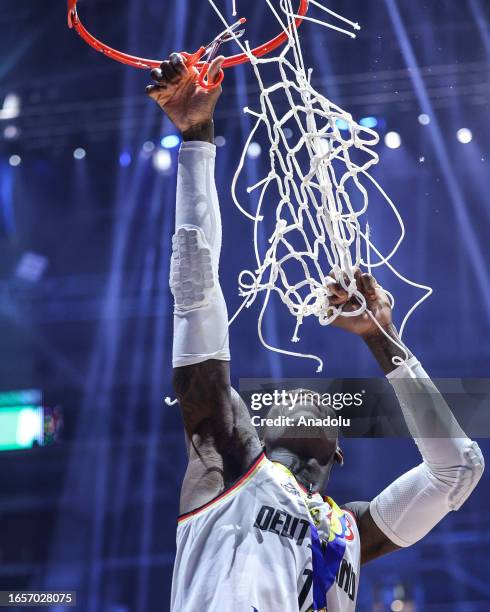 Germany's Dennis Schroder cuts the net as the Most Valuable player during a ceremony after winning FIBA World Cup finals against Germany at the Mall...