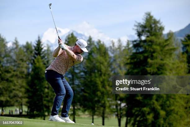 Connor Syme of Scotland plays his second shot on the 11th hole during Day Four of the Omega European Masters at Crans-sur-Sierre Golf Club on...