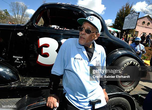 Wendell Scott Jr. Sits next to a historical race car during a ceremony for the unveiling of a historical marker in honor of his father, Wendell O....